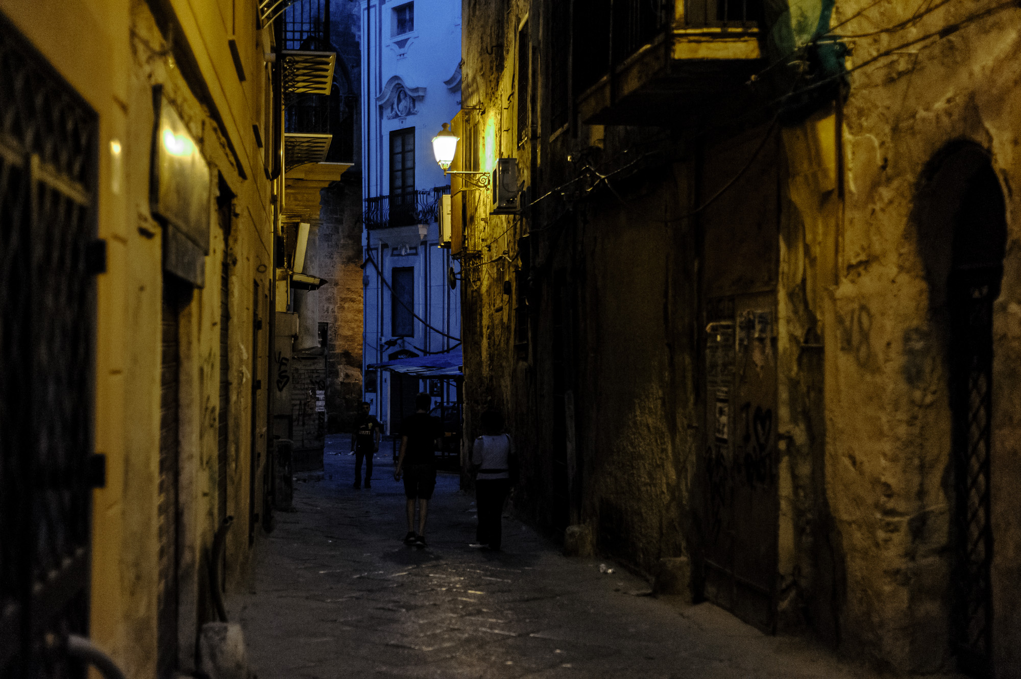 People walking in the narrow streeets of Palermo historic center. Nikon D700 ISO 6400